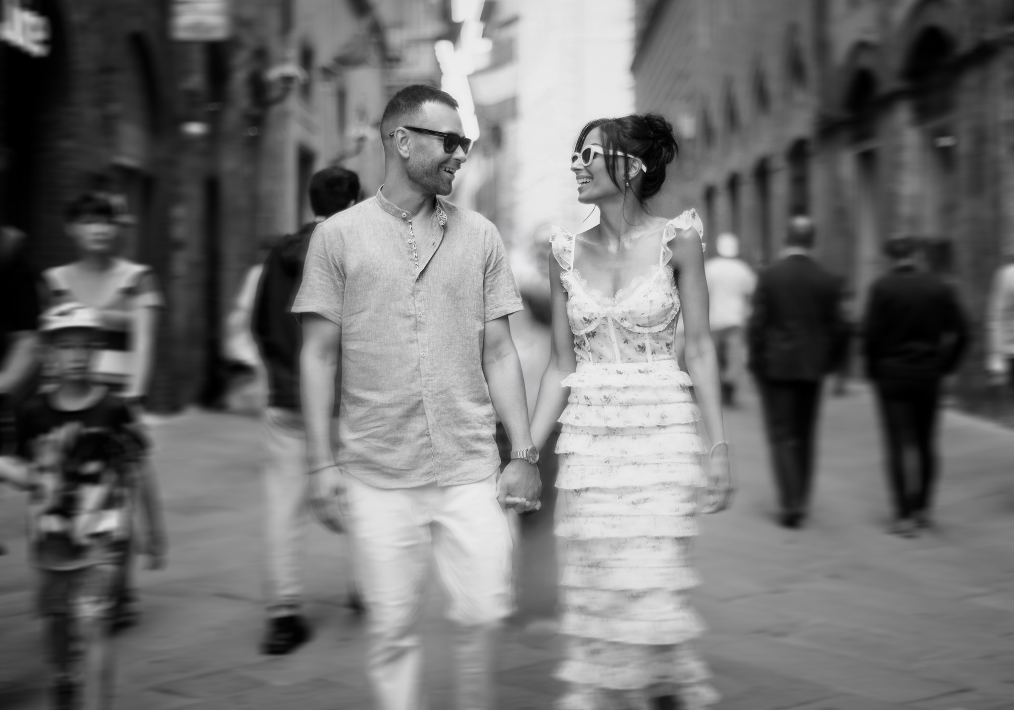 Newlywed couple walking through a busy city street during their destination wedding