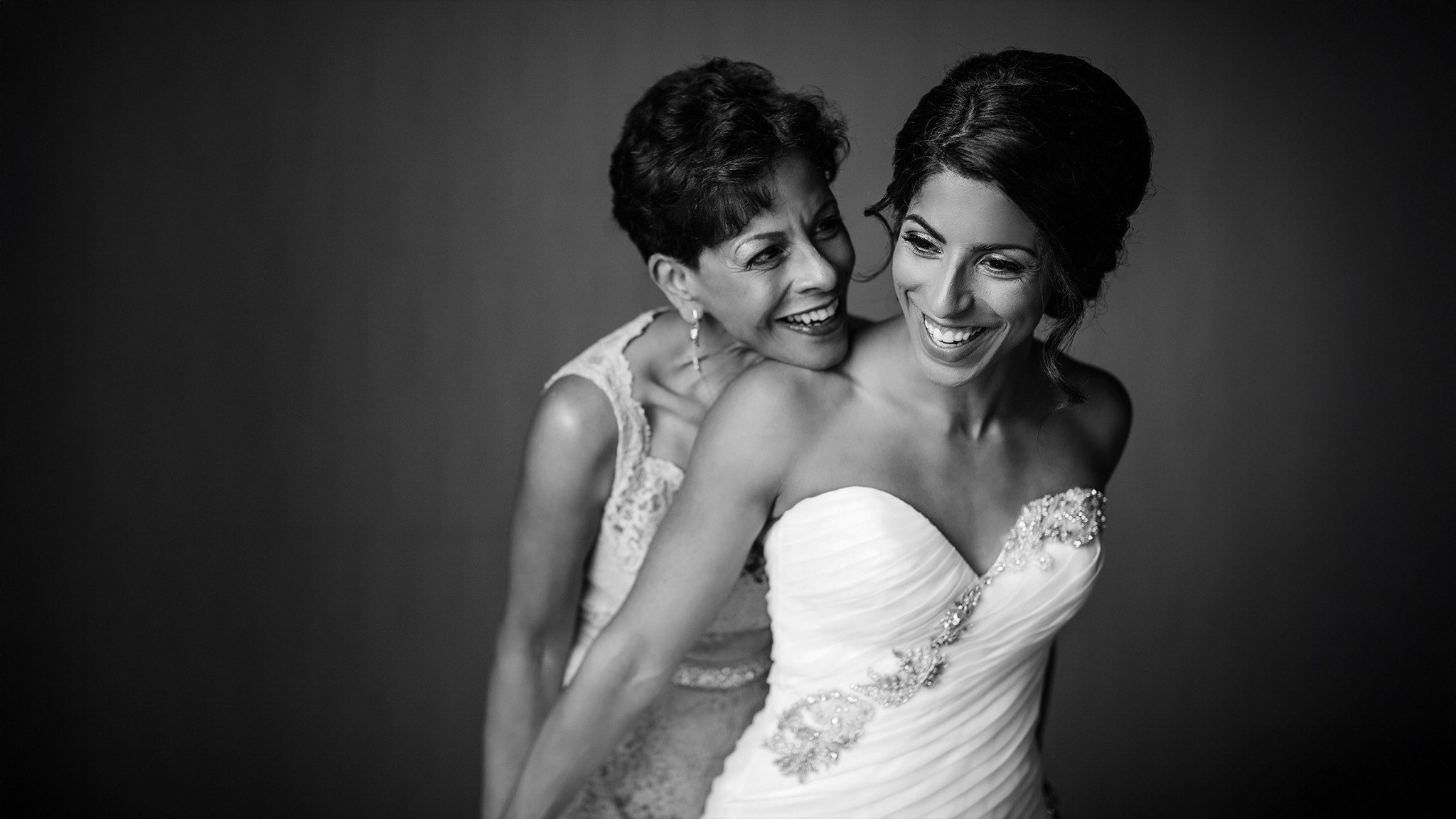 Mother sharing an emotional moment with her daughter before the wedding ceremony