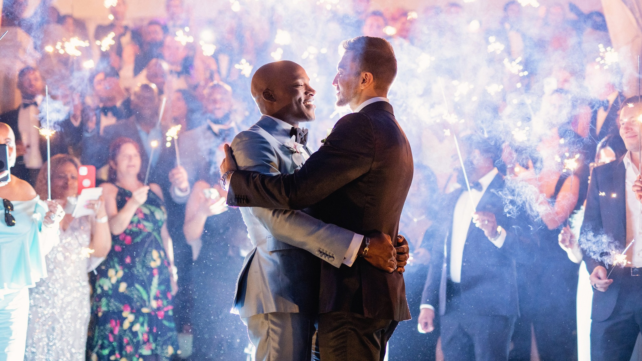Kyle and Erik celebrating with their guests and sparklers